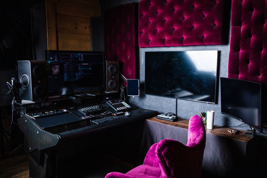The studio control desk with tufted velvet wall panels